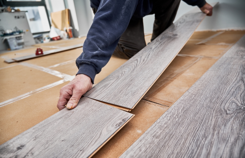 Close,up,of,man,hands,laying,laminate,wooden,planks,on